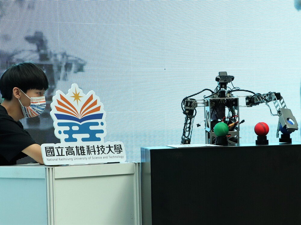 A student from the Autonomous Intelligent Robotics Systems Laboratory of EE maneuvered the automated robot to pick and place balls.