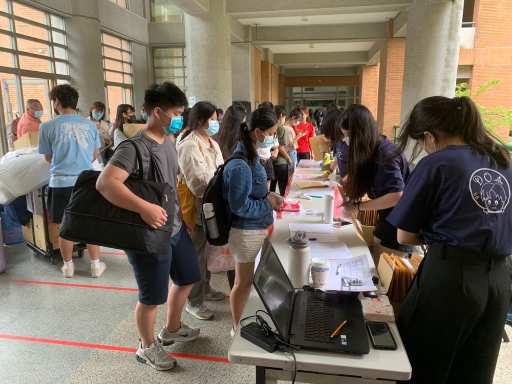 Teachers and dorm staff helped incoming freshmen with the check-in process.