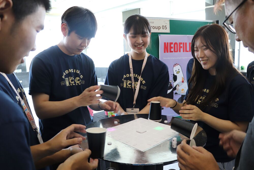 The second and third place winners of the 2025 ICDC secured the Excellence Prize, with their projects themed NEOFLIP 25 and Drawing Party, respectively. Pictured is the NEOFLIP 25, designed with a sensing device: if a player successfully flips an empty cup to cover the sensor, they can pass the turn, while the loser receives a penalty, making it a highly effective icebreaker.